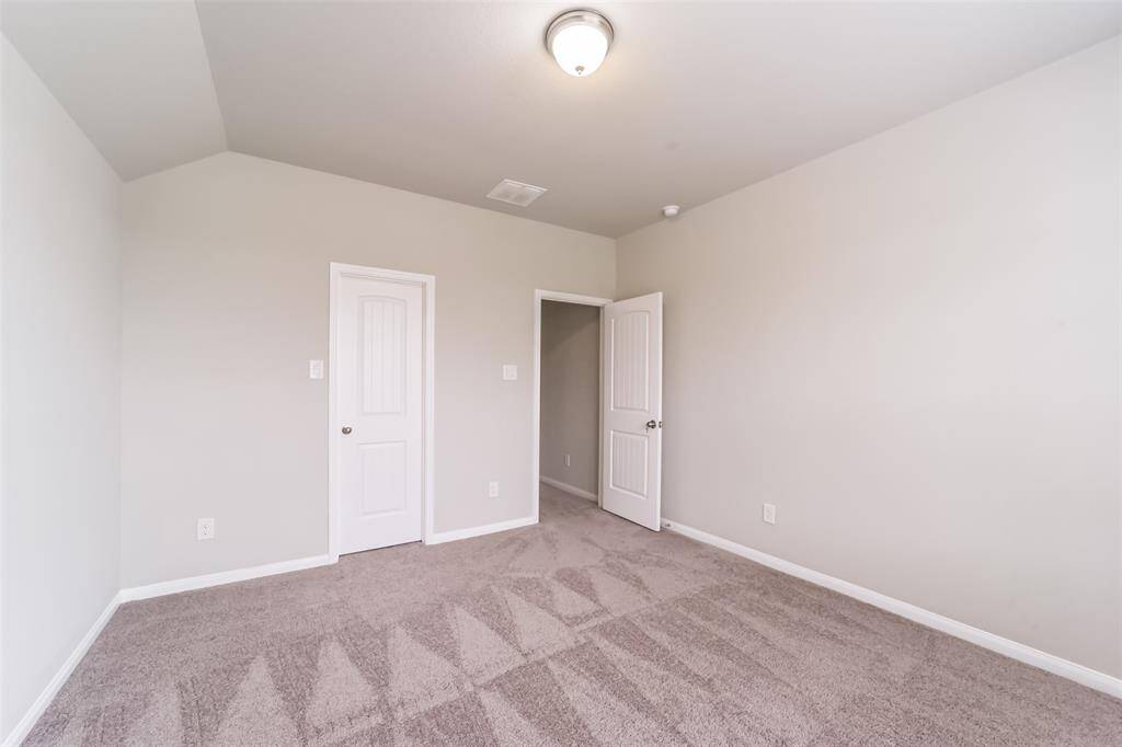 Cozy, this secondary bedroom features ample natural light that highlights the stunning room and gray tones throughout.