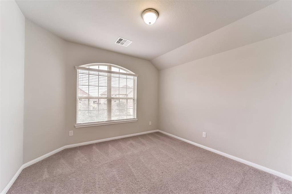 Light and bright secondary bedroom, this light filled room features a large window and a nicely-sized closet.