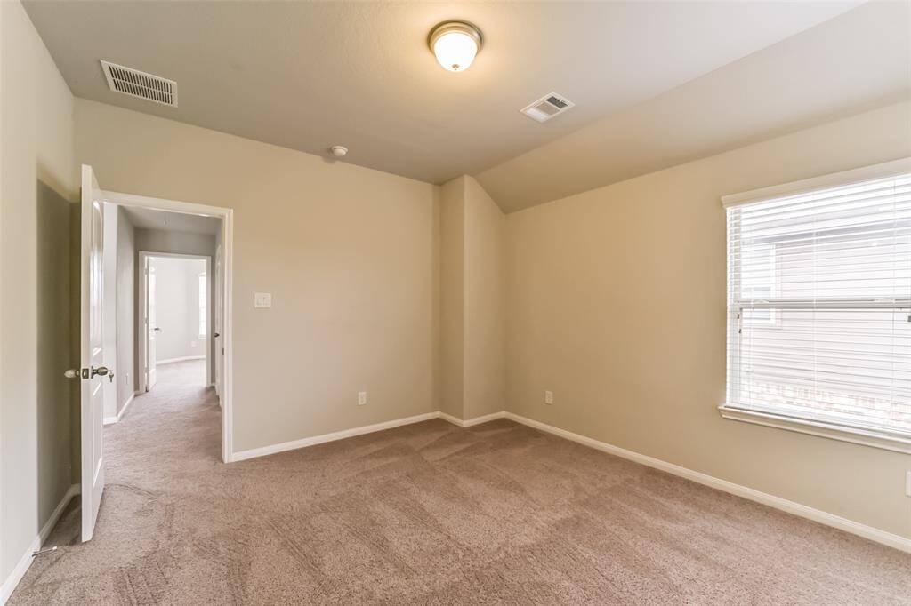 Light and bright secondary bedroom, this light filled room features a large window and a nicely-sized closet.