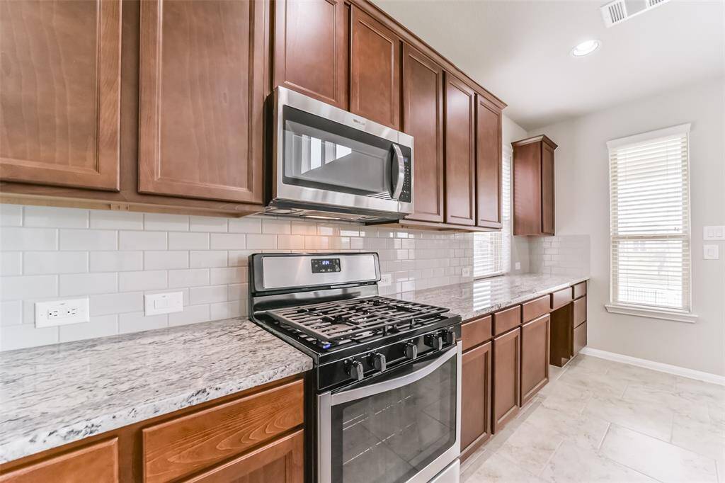 Gas stove with beautiful cabinets, barely touched.