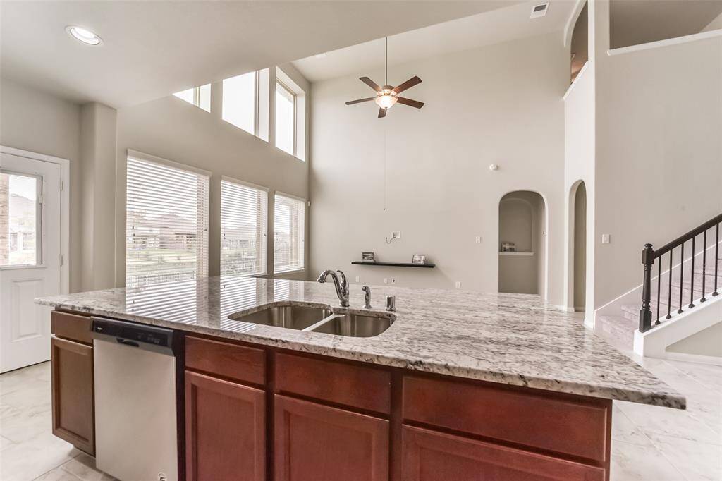 Fit for a chef, the kitchen is fully equipped with a top of the line professional stainless steel appliances. The sink is centered on the island is perfectly located as you can entertain guests while preparing meals.