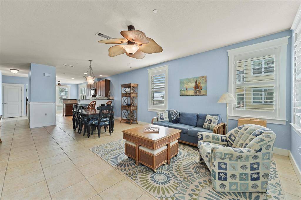 This thoughtfully designed living room combines style and function with its coastal decor, cozy seating, and easy flow into the dining and kitchen areas. It’s the perfect space to relax after a day of exploring Pointe West's picturesque surroundings.