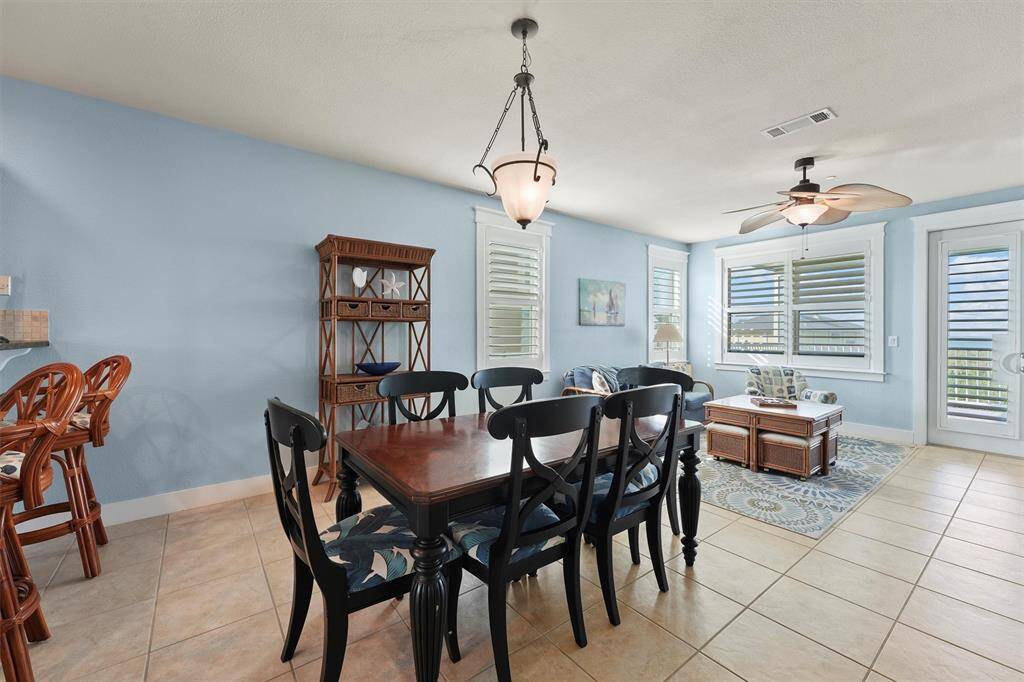 Set against a backdrop of soft blue walls and bright natural light, this dining area comfortably seats six and connects effortlessly to the living room and breakfast bar, making it perfect for both intimate dinners and larger gatherings.