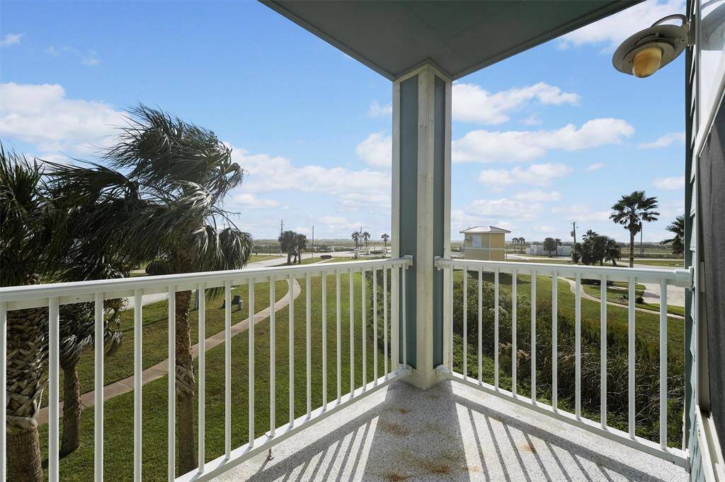 Step onto the second balcony off the bonus room for a refreshing escape, with peaceful views of the lush landscaping and swaying palms. This private outdoor space is perfect for enjoying the gentle coastal breeze and scenic surroundings.