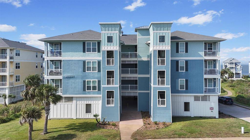 The charming architecture and coastal colors of the condo buildings reflect the relaxed beach vibe of Pointe West, harmonizing with the natural surroundings.