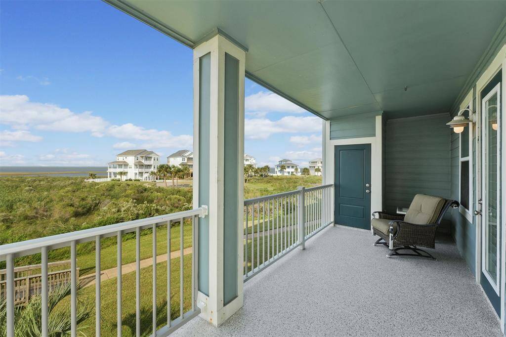 Unwind on this peaceful balcony with panoramic views of the lush surroundings, capturing the essence of bayside living.