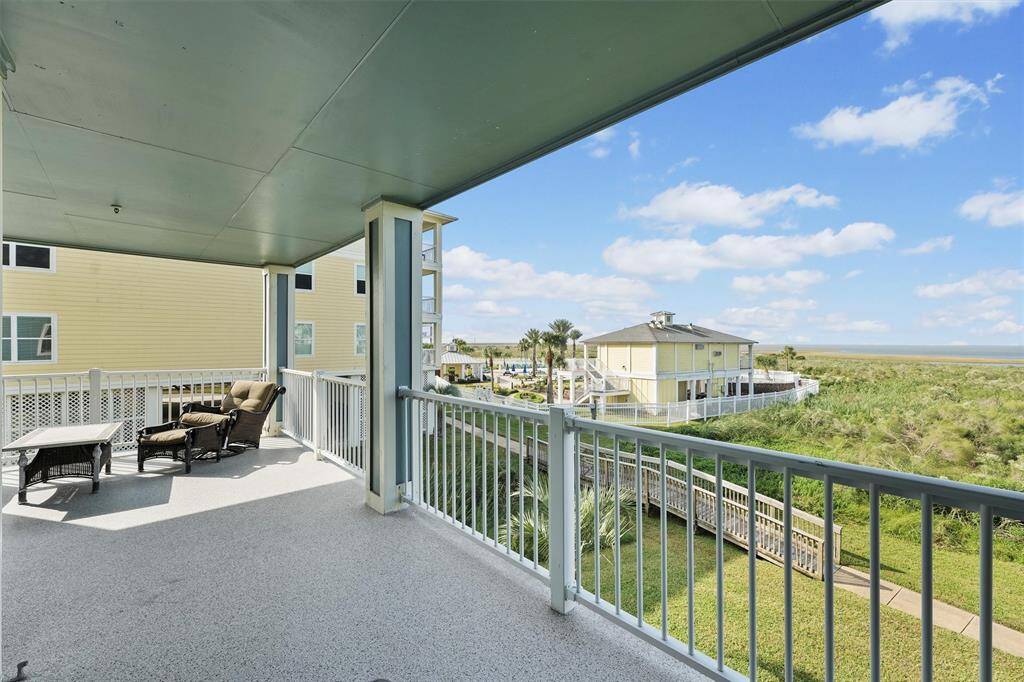 Spacious and shaded, this private balcony offers a perfect spot to relax and enjoy the coastal breeze, with poolside views just steps away.