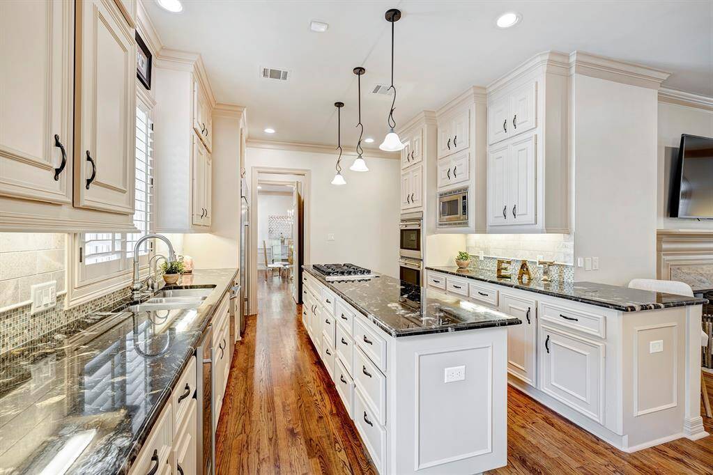 Island kitchen has beautiful black and white granite counters. Some appliances replaced in 2014.