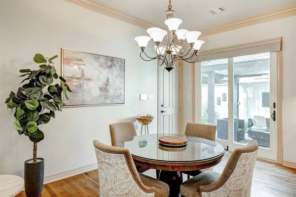Breakfast room shows the sliding glass door to the covered area and garage door to the left..