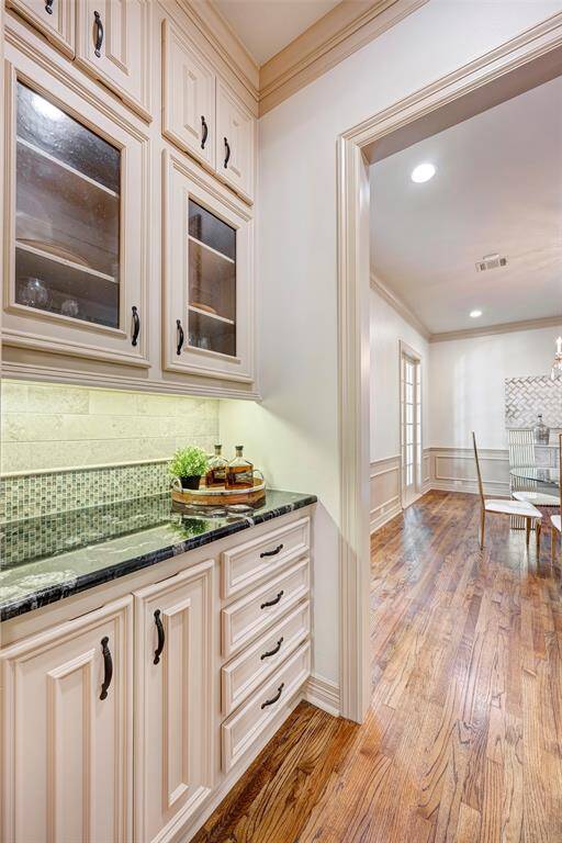 Butlers Pantry. Across from it is a generous walk in pantry for your Costco or Sams Club trips. Glass cabintry adds the custom touch. A good number of drawers for silverware or wedding gifts  ;you don't use..