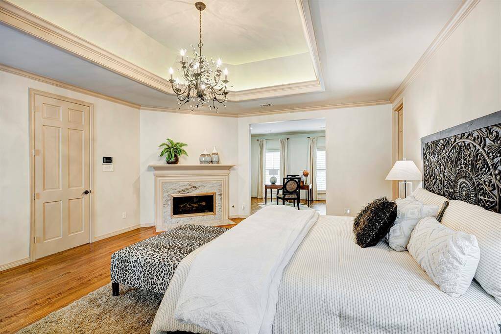 The sitting room for the primary room is seen in the background. Can be another TV room with a couch or a study/office. Is private. One time it opened to the hall. The door to the right of the bed goes to the primary bathroom. There used to be another opening on the other side of the bed.