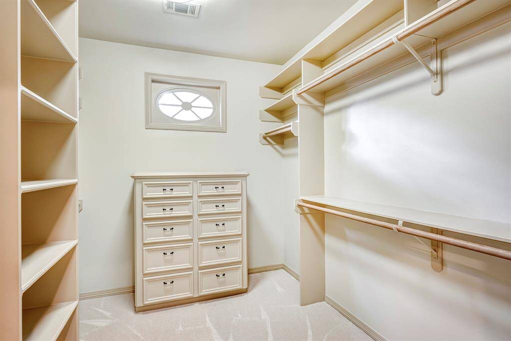 Closet 1 with a small window and built ins.