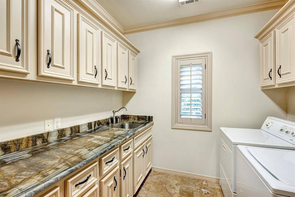 Laundry room on 2nd floor has lots of cabinets and a sink. Nice to have window too! Washer/dryer stay.