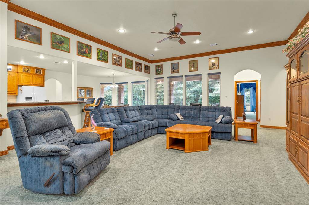 This expansive living room combines comfort with elegance, featuring plenty of natural light, an open layout, and a welcoming atmosphere perfect for relaxing or entertaining. Imagine cozy evenings or gathering with loved ones in this beautiful space.