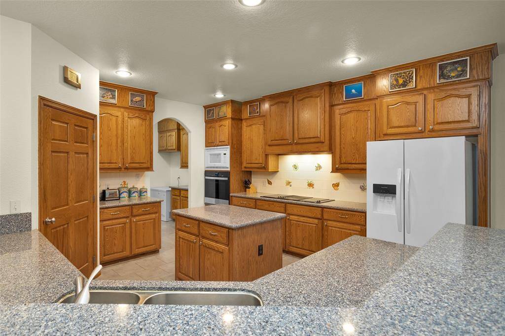 The kitchen is a chef’s delight, with ample cabinetry  and a spacious layout designed for cooking ease and efficiency. Plenty of counter space makes meal prep a breeze, while the open design allows for easy conversation and flow to the adjoining areas.