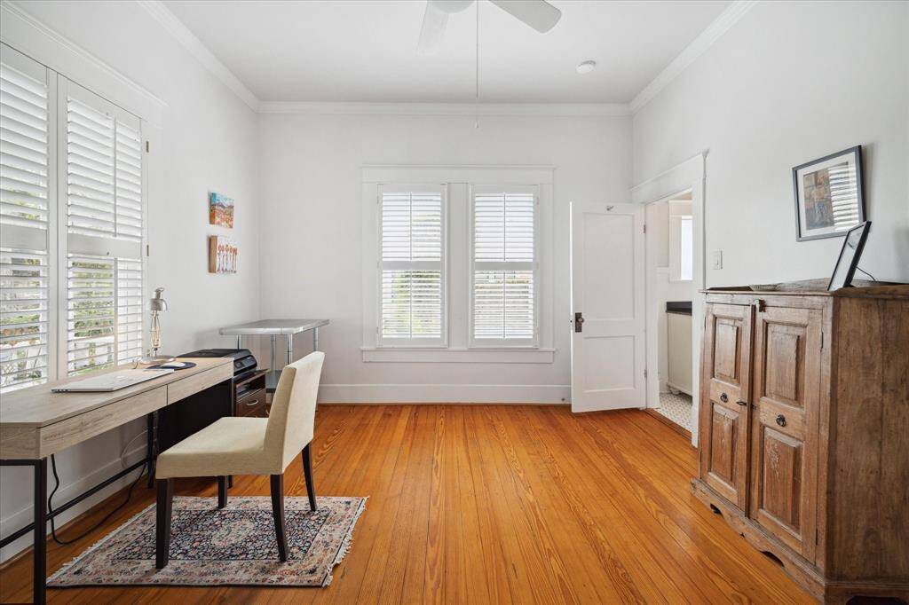 The second bedroom is bright, spacious and airy, featuring large windows that fill the space with natural light, plantation shutters, ceiling fan along with crown molding that adds a touch of elegance.