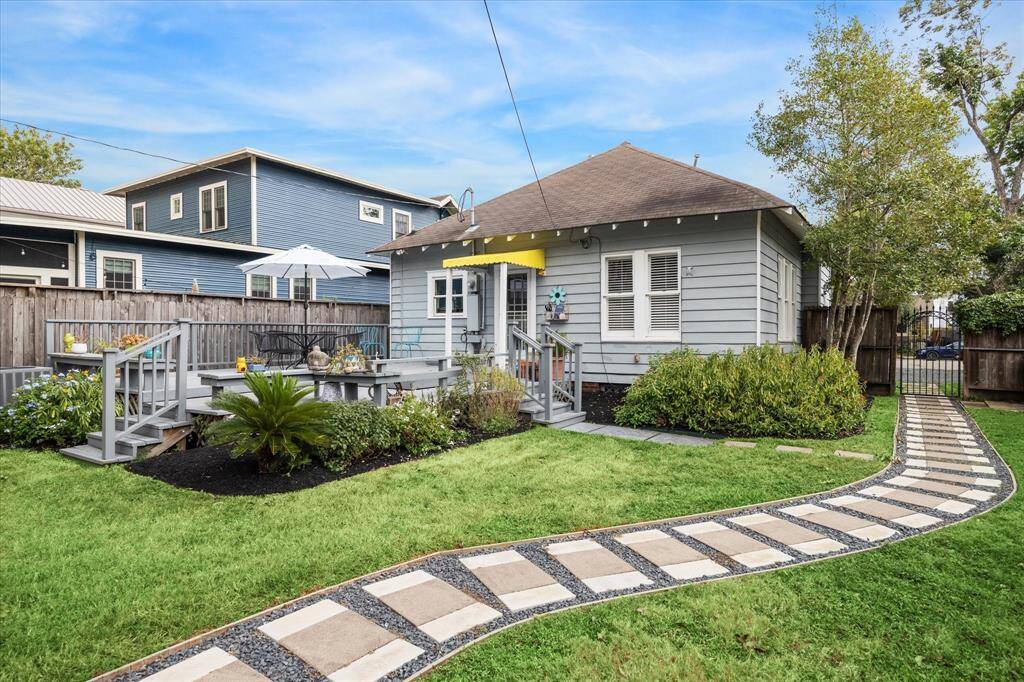 Another view of the back patio, ideal for outdoor enjoyment and surrounded by beautiful landscaping, offering a serene and inviting outdoor space.