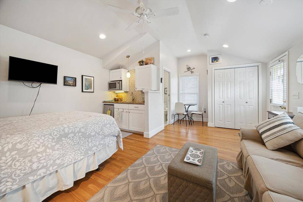 A convenient kitchenette, featuring a mini refrigerator, sink, and microwave, makes this guest house fully functional for hosting guests.