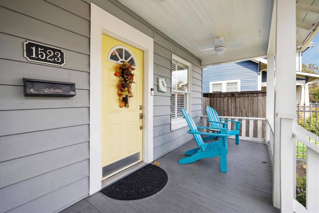 The cheerful yellow front door is just one of the many charming and inviting features of this home.