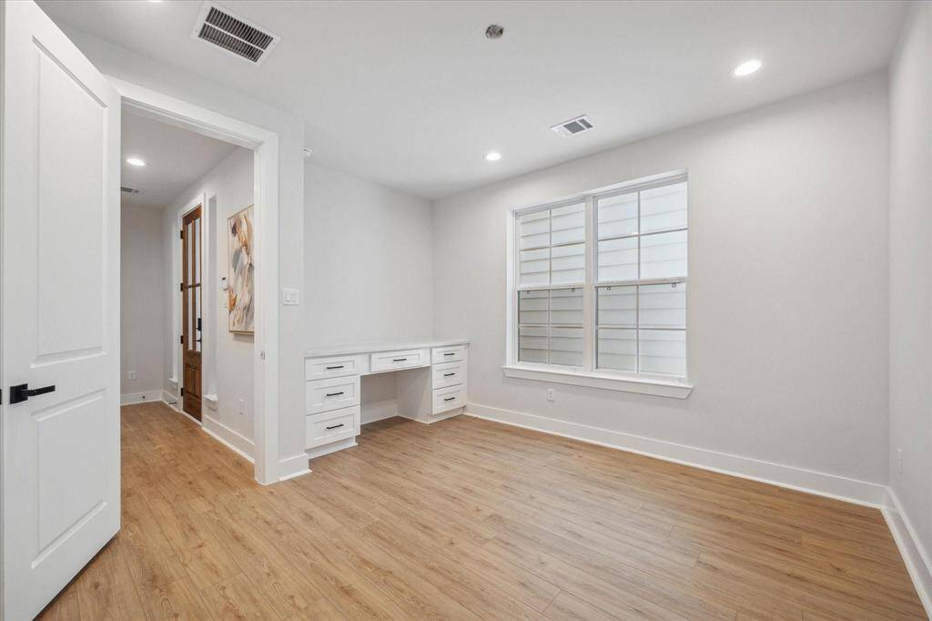 Bedroom on the 1st floor features a built-in desk that could easily be turned into a home office