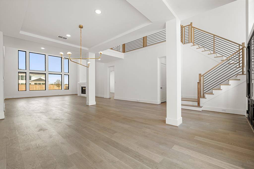 Step into a stunning grand foyer featuring soaring ceilings, elegant lighting, and a spacious layout that sets the tone for the rest of the home.