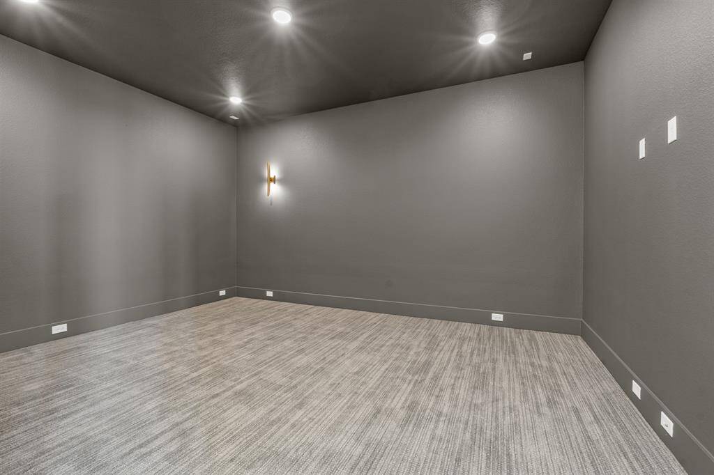 Enjoy movie nights and game days in this spacious downstairs media room, designed for comfort and entertainment.