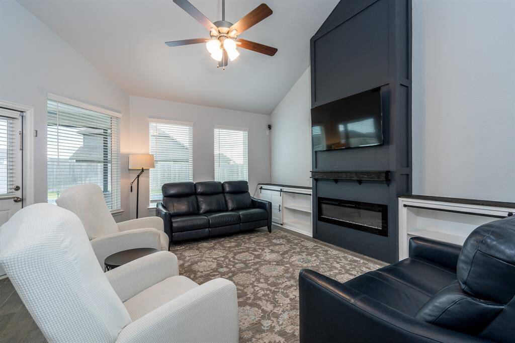 This gorgeous two-story family room offers the perfect gathering space to warm up by the fire or entertain family and friends!