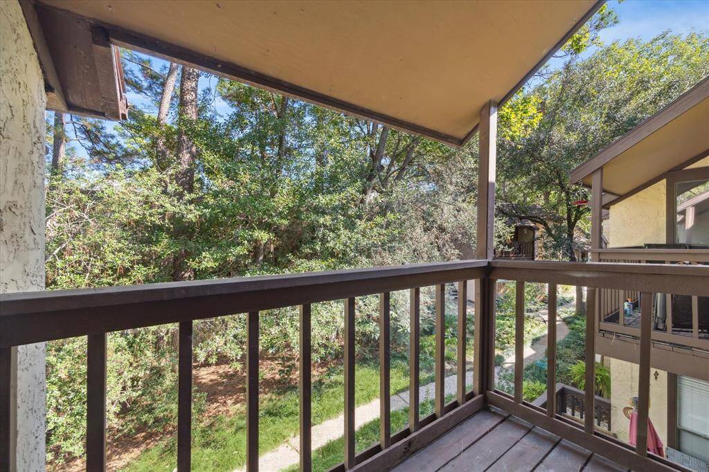 Balcony overlooks wooded courtyard