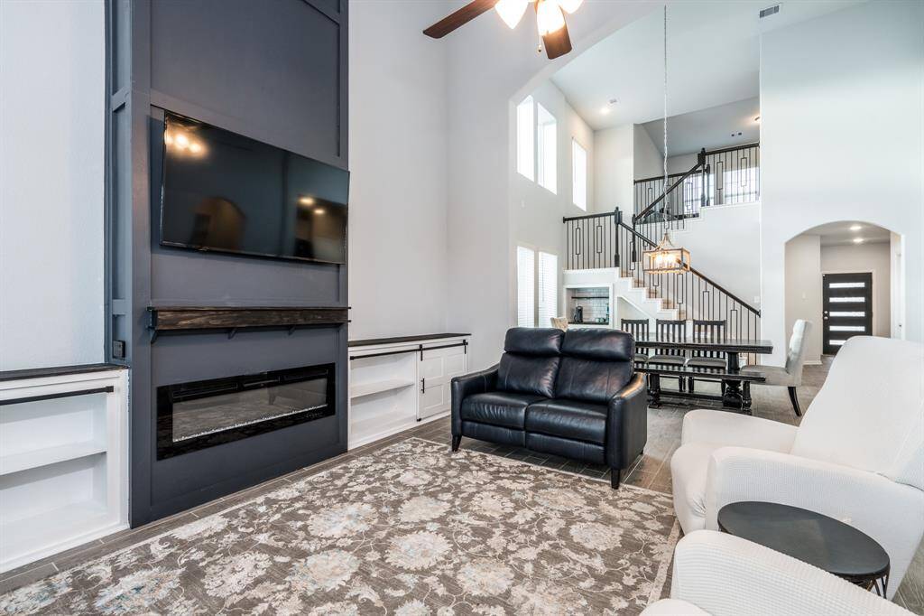 The focal point of the family room is this custom built in with electric fireplace and floor to ceiling modern accent wall!