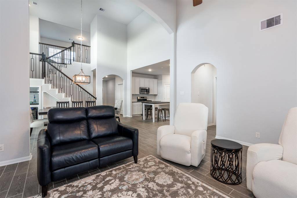 This view of the family room showcases the bright, open flow of this home with its beautiful arched accents!