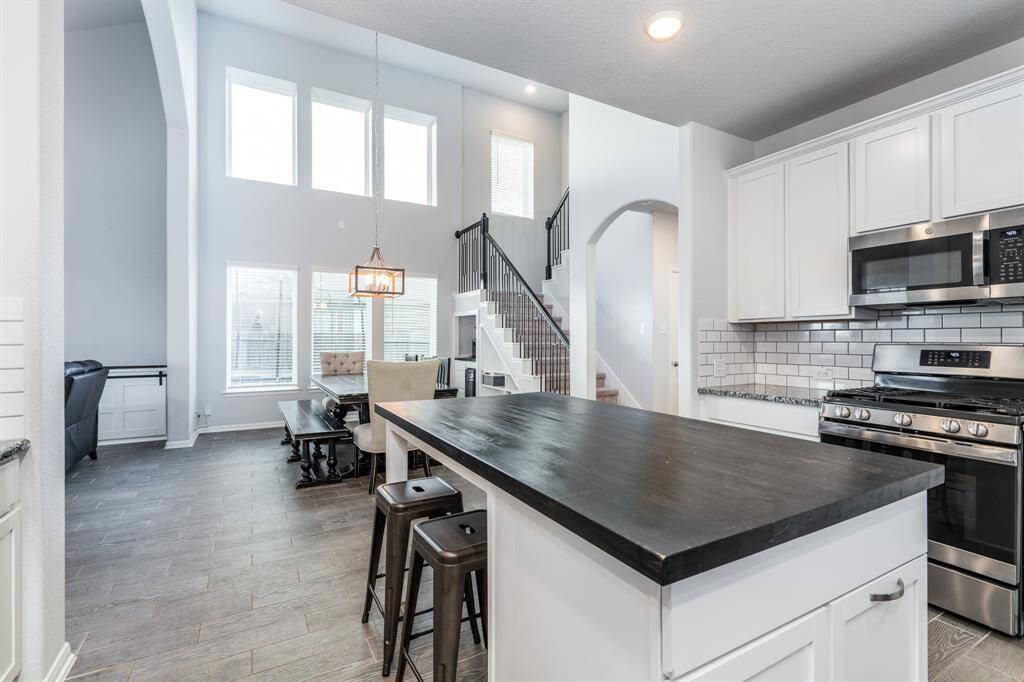Across from the casual dining area and open to the family room is the spacious kitchen with custom island!