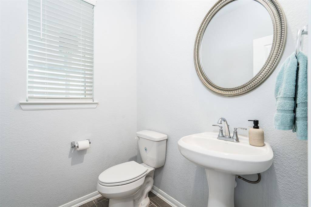 Just off the family room is this charming powder room with pedestal sink, just the right place for guests to freshen up!