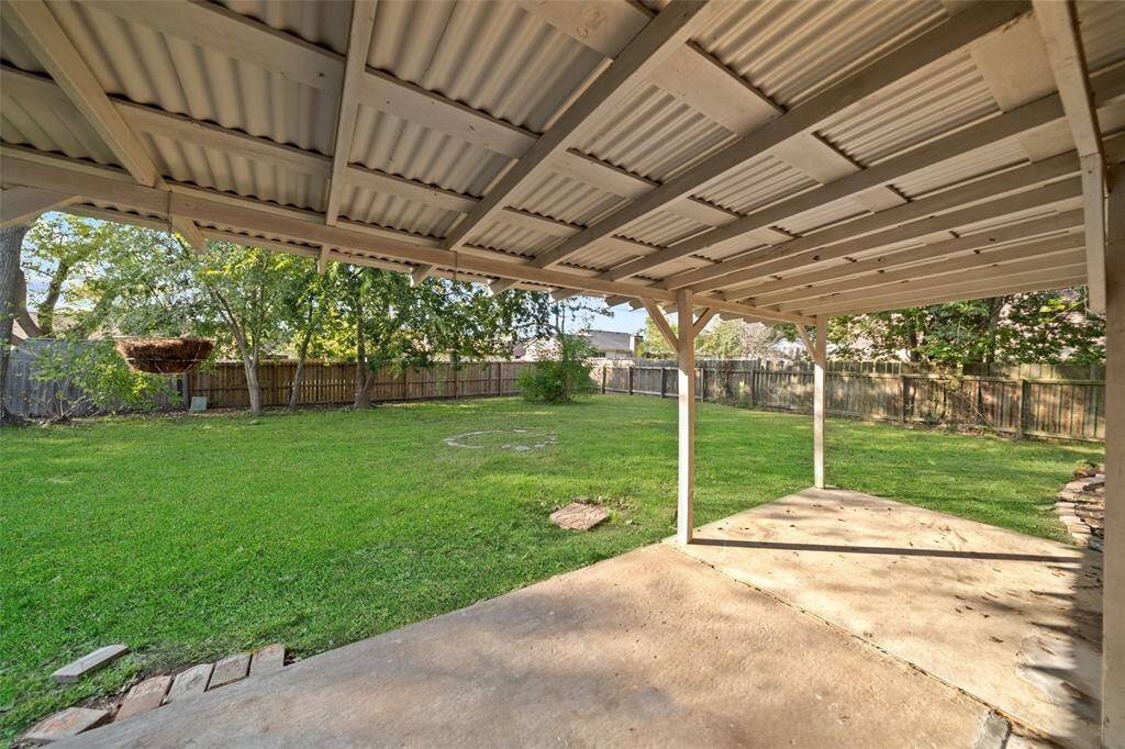 Covered back patio and fully fenced backyard.