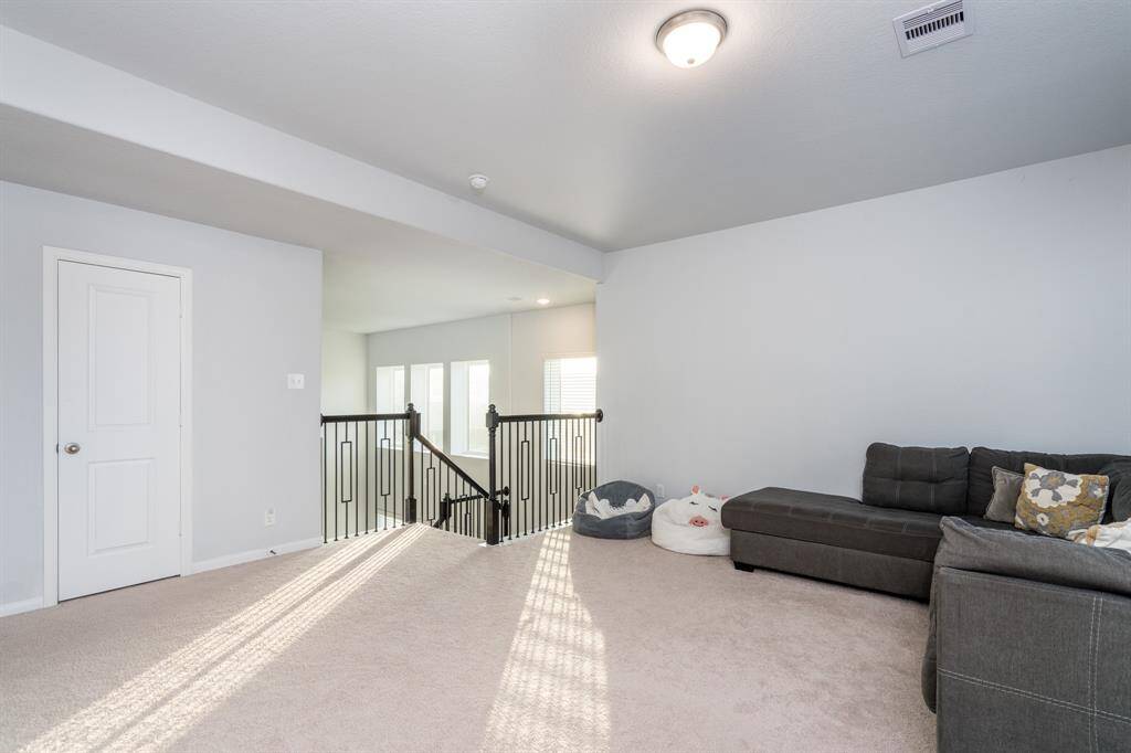 Once upstairs, you will find the huge game room! It offers plenty of space to take in a movie, get in a workout, or whatever entertaining you desire!