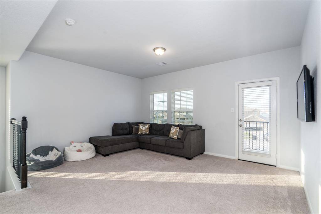 The game room features neutral paint and carpet, a large storage closet, plus a bonus walk out balcony overlooking your spacious front yard!