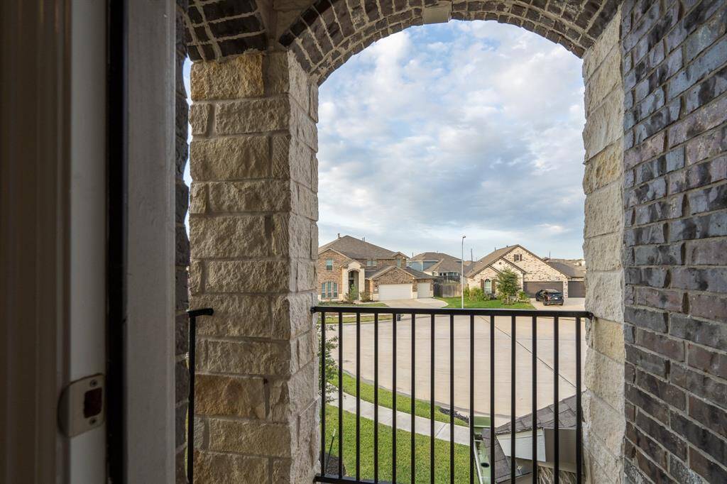 Imagine enjoying your morning coffee on this charming balcony located off the game room!