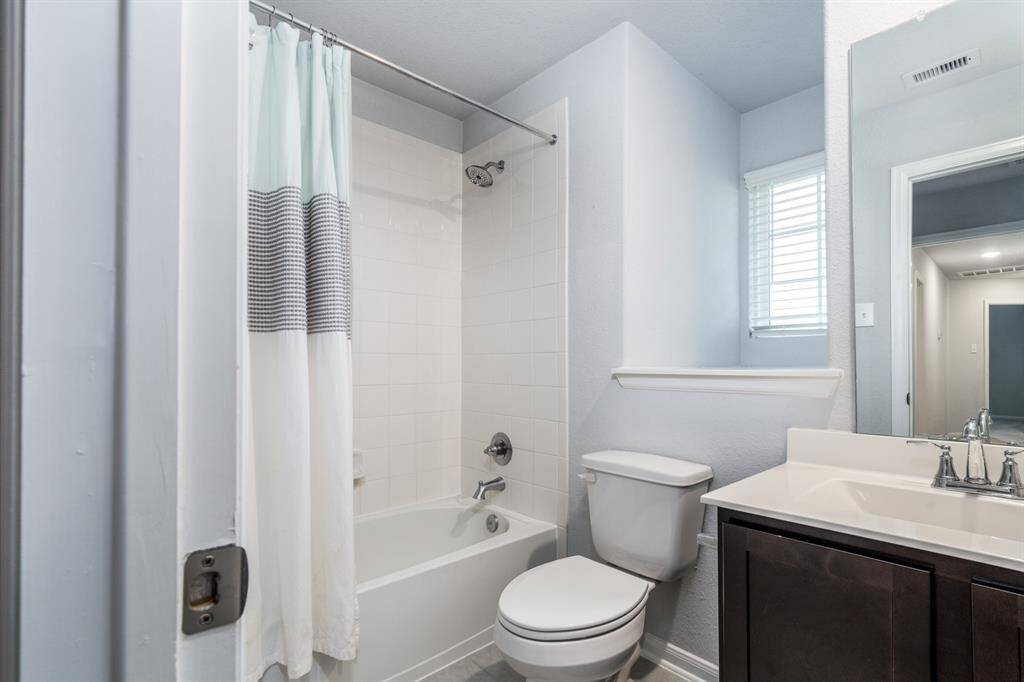This full bath offers a shower/tub combo with tile surround, a spacious vanity and is the perfect place for residents or guests to start or end their day!