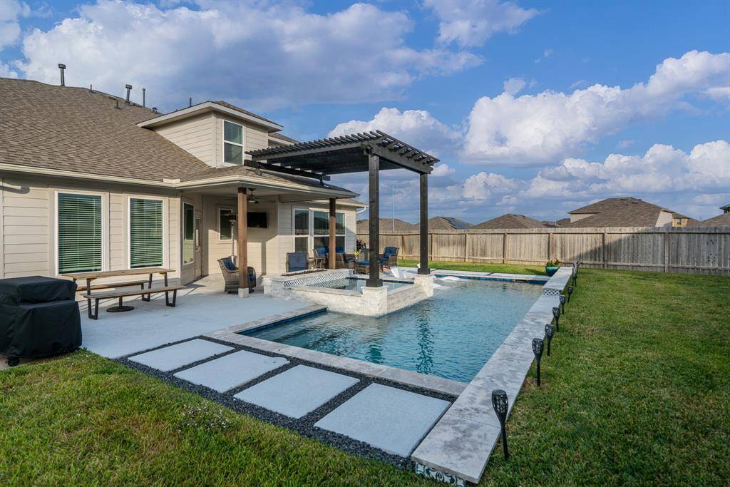 Extending decking and stone pavers offer a great place to relax poolside and would make the perfect spot for an outdoor kitchen!