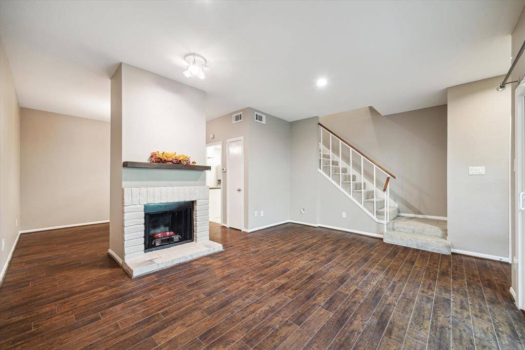 View of living with fireplace looking into dining area