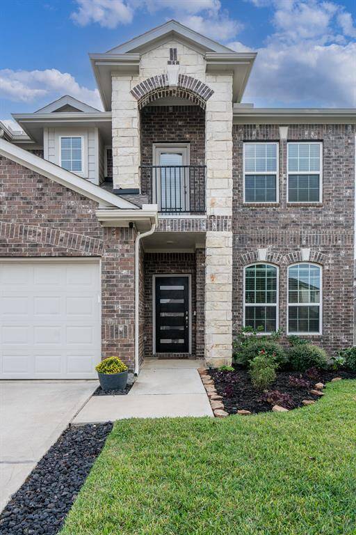 Stone and brick elevation with a landscaped front walk welcome all who enter!