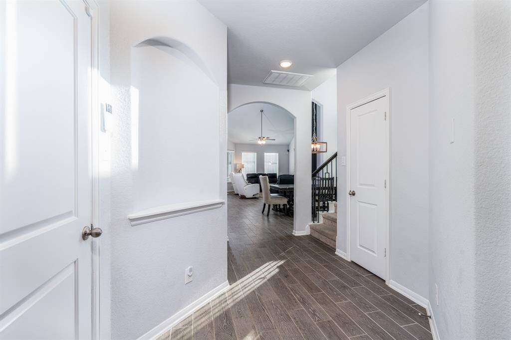 Step inside this light and bright entry with easy to maintain wood tile flooring that flows throughout the main living areas.