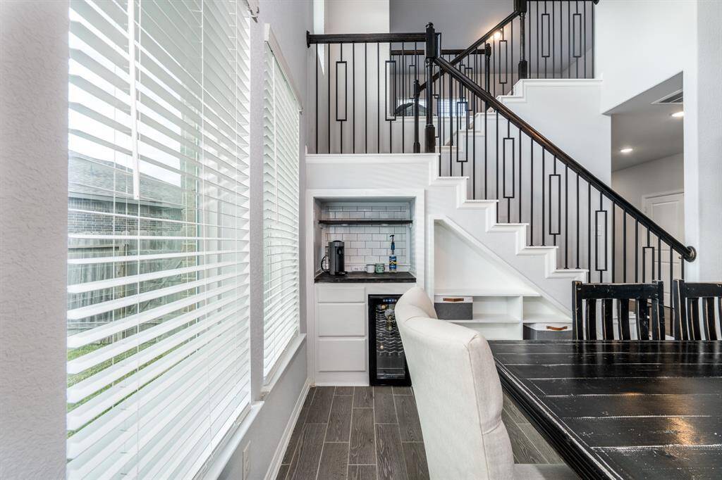 Tucked creatively under the staircase is your very own beverage/coffee bar, complete with subway tile and wine fridge! It's the perfect finishing touch to this entertainer's dream space!