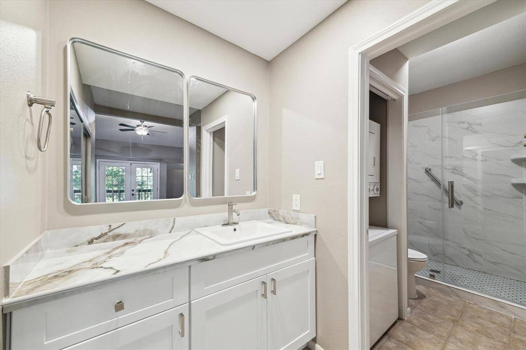 Bath updates include cabinets, sink, mirrors. Large shower with glass door. Stacked washer and dryer.