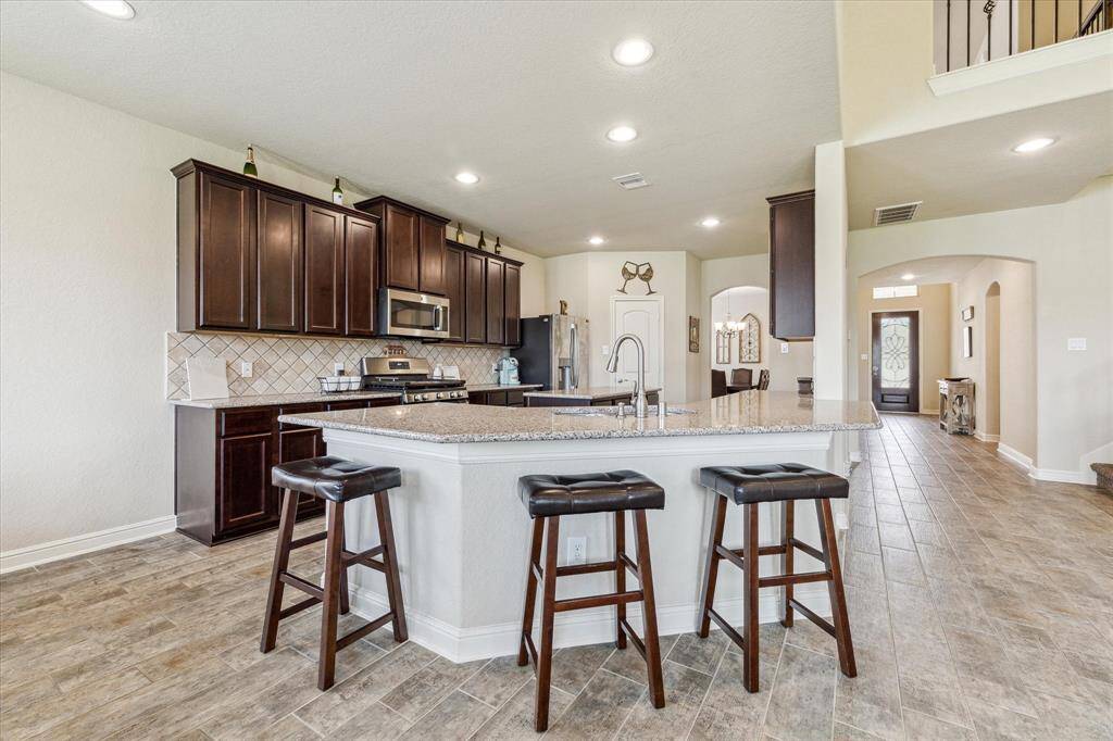 Plenty of room for additional bar seating in this wrap around breakfast/ serving bar.