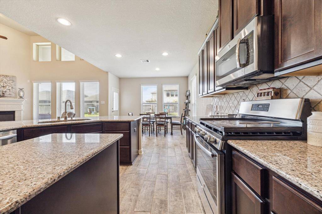Just look at all the beautiful, large windows. The open layout provides plenty of natural light and flows seamlessly into the dining area, ideal for entertaining.