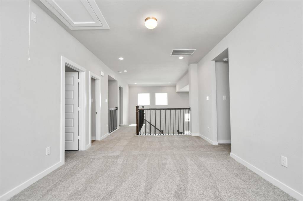 Ascend to relaxation in this fantastic game room! Ideal for both casual gatherings and adult gaming, it boasts plush carpet, lofty ceilings, custom paint, and ample windows for abundant natural light. Sample photo of completed home with similar floor plan. As-built interior colors and selections may vary.