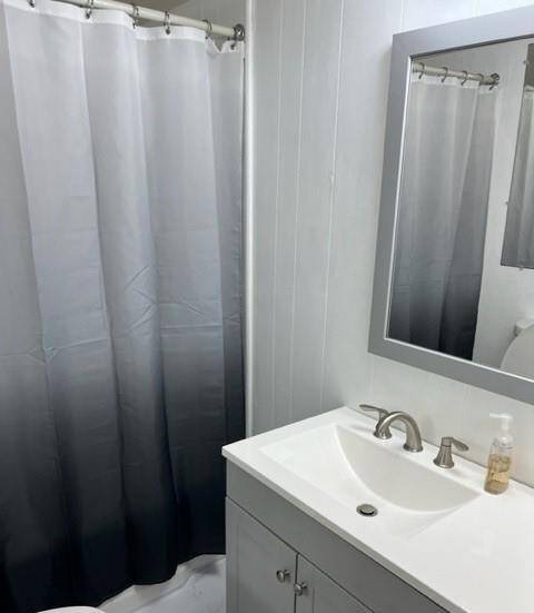 Remodeled full bathroom with new vanity, toilet, shower and flooring.
