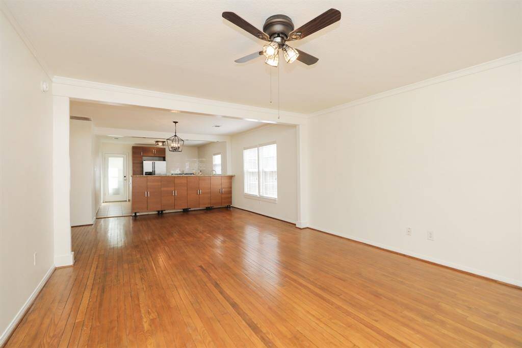 Large den, dining area have oak floors, ceiling fan and recent lighting.