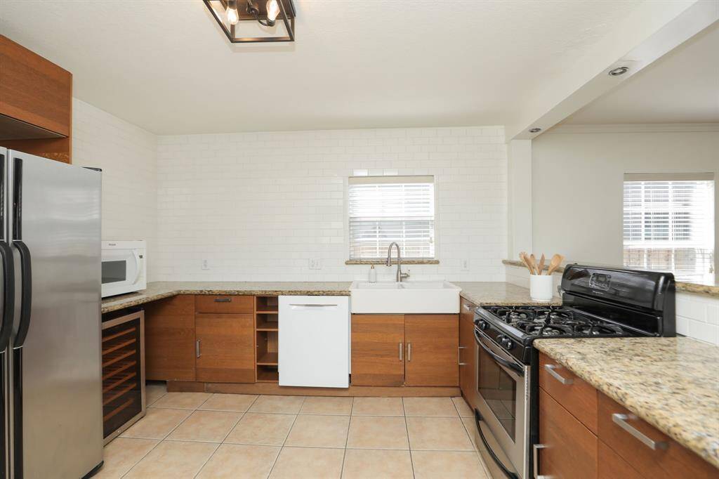 View of farm sink and gas range.
