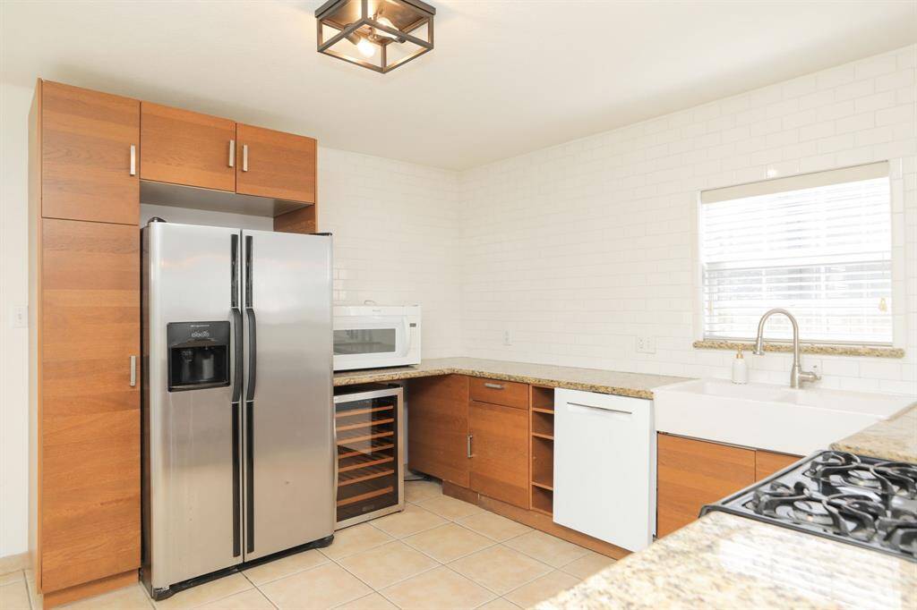 View of wine fridge and microwave.